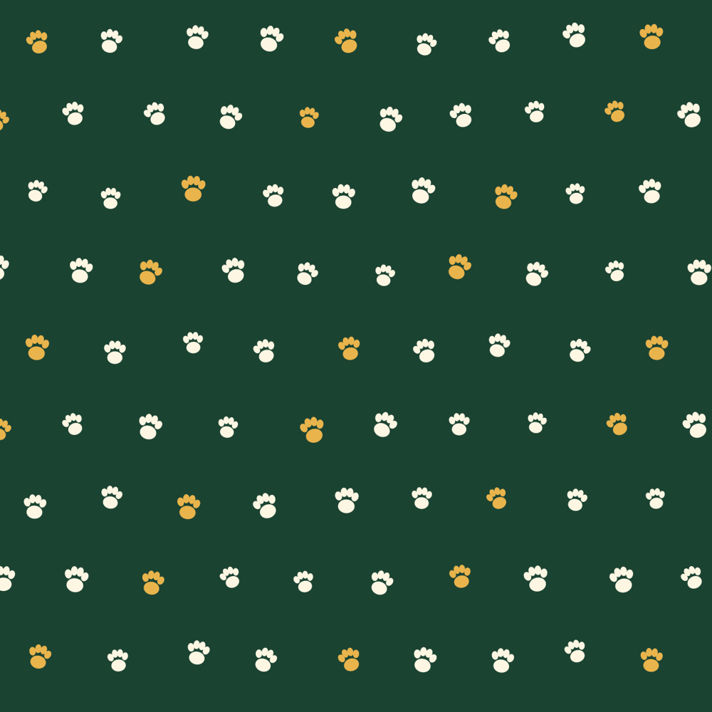Dog bandana with cream and honey paw prints on deep forest green
